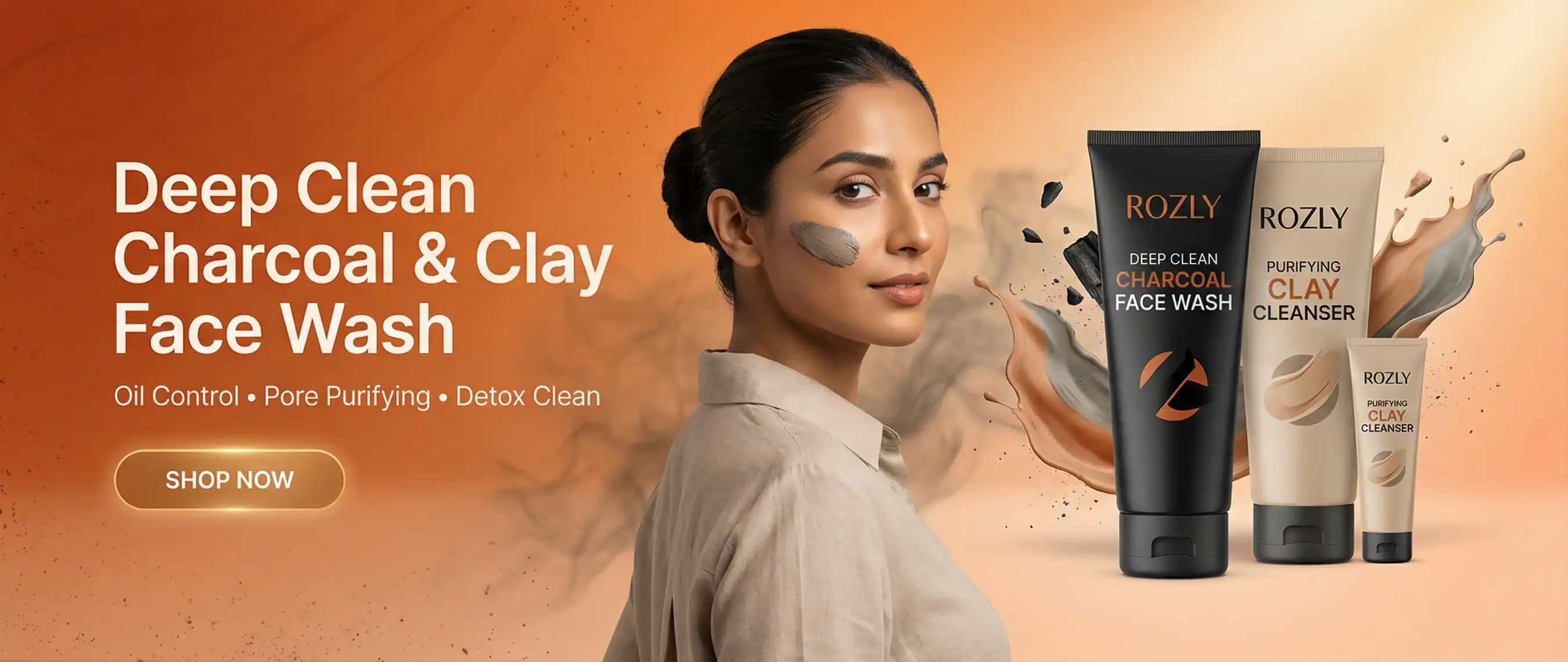 A woman with a clay face wash sample on her cheek posing next to ROZLY Deep Clean Charcoal Face Wash and Purifying Clay Cleanser tubes, featuring a matte black and tan aesthetic against a warm orange gradient background.